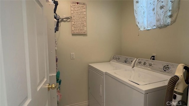 clothes washing area with laundry area and separate washer and dryer