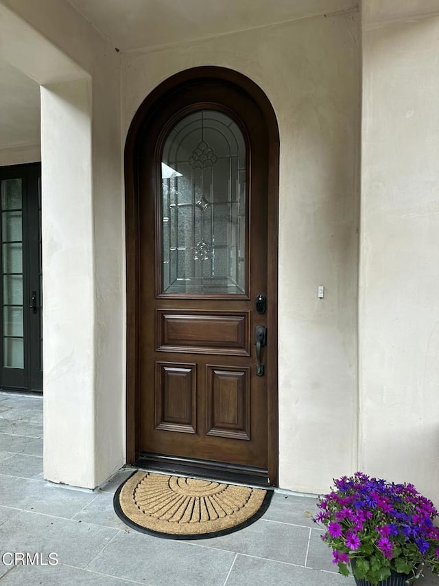 property entrance with stucco siding