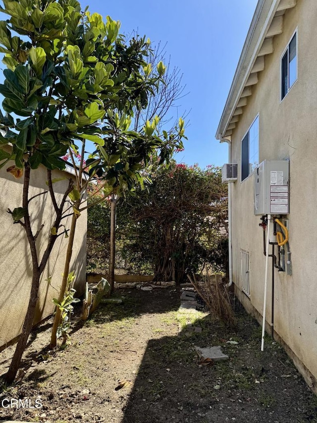 view of yard featuring a wall mounted AC