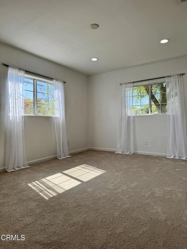 carpeted empty room with recessed lighting and baseboards