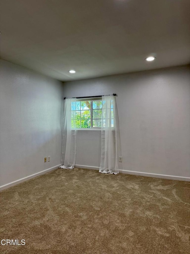 spare room with carpet flooring, recessed lighting, and baseboards