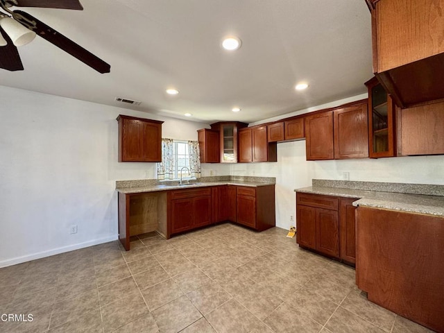 kitchen featuring a ceiling fan, visible vents, recessed lighting, a sink, and glass insert cabinets