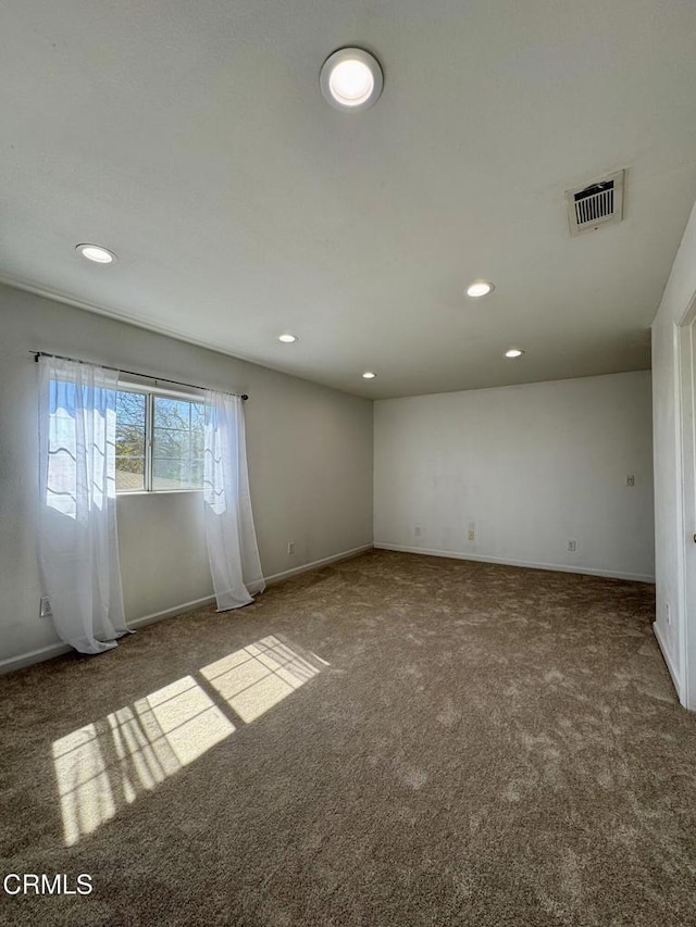 empty room with visible vents, recessed lighting, baseboards, and carpet floors