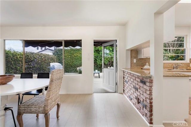 dining room featuring plenty of natural light and light wood-style flooring