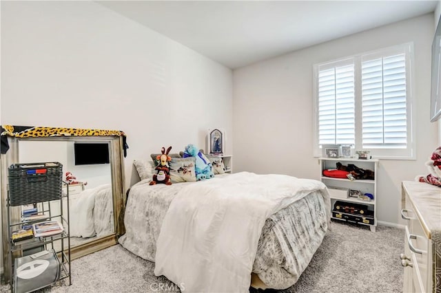 bedroom featuring baseboards and light carpet