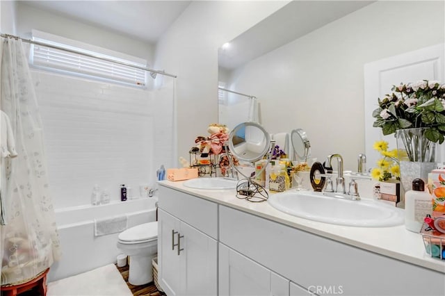 full bathroom with a sink, shower / tub combo with curtain, double vanity, and toilet