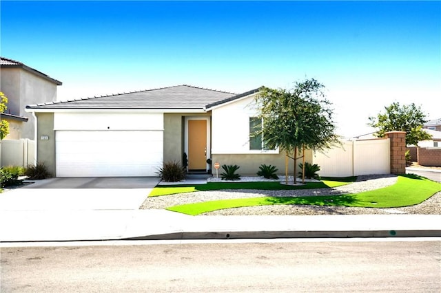 view of front of home with a tiled roof, stucco siding, an attached garage, and concrete driveway