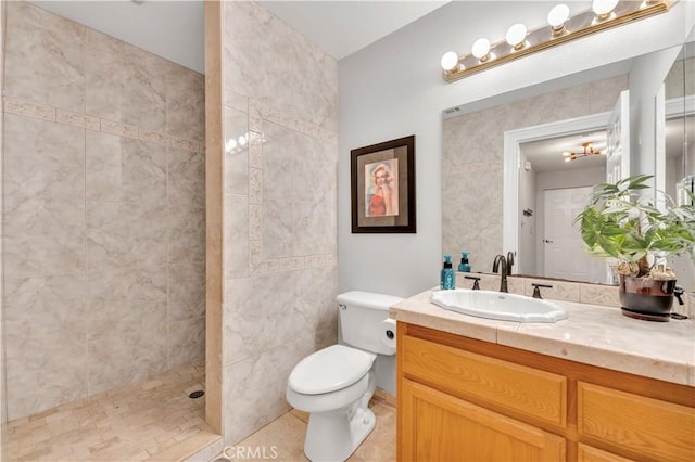 bathroom featuring toilet, walk in shower, vanity, and tile patterned floors