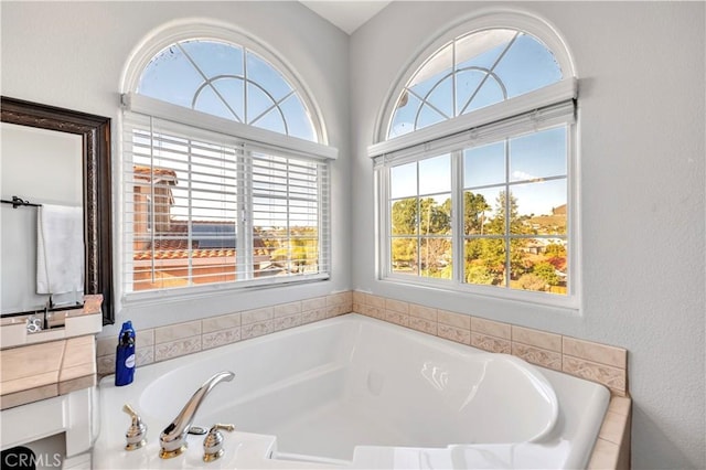 full bath with a bath and vanity