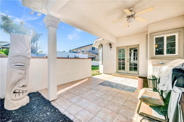 view of patio / terrace featuring fence, a ceiling fan, and french doors