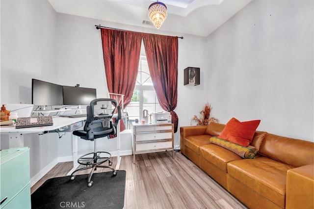 office space with wood finished floors and baseboards