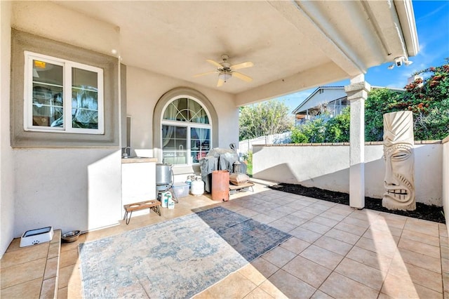view of patio featuring fence and a ceiling fan