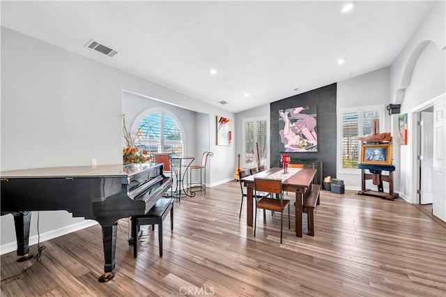 dining area with vaulted ceiling, baseboards, visible vents, recessed lighting, and wood finished floors