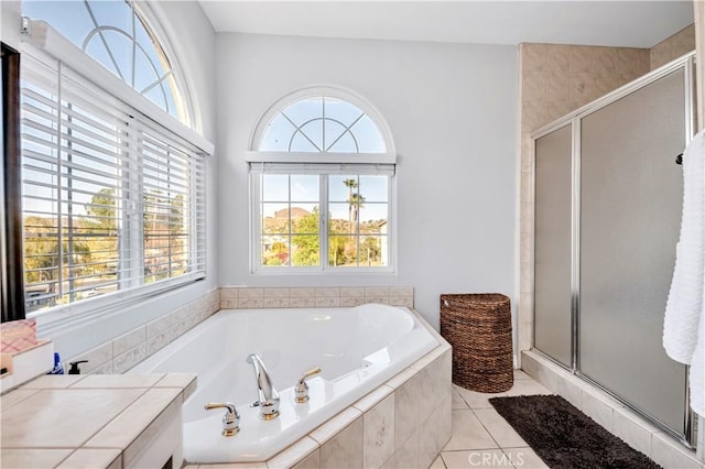 bathroom with a bath, tile patterned flooring, and a stall shower