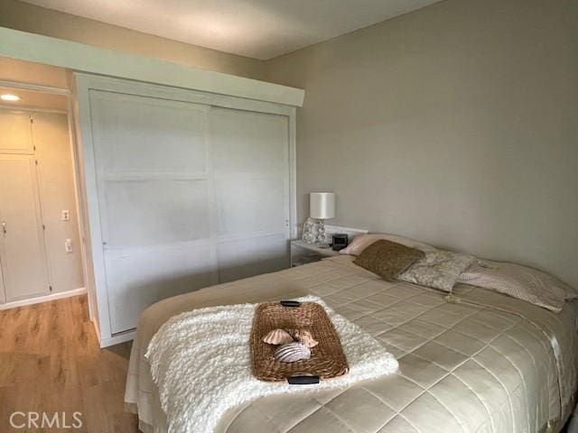 bedroom with a closet and light wood-style floors