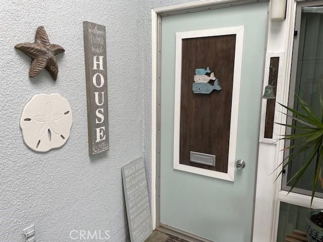 property entrance featuring stucco siding