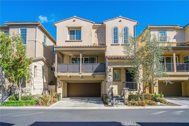 mediterranean / spanish-style home featuring stucco siding, central air condition unit, a tile roof, concrete driveway, and a garage