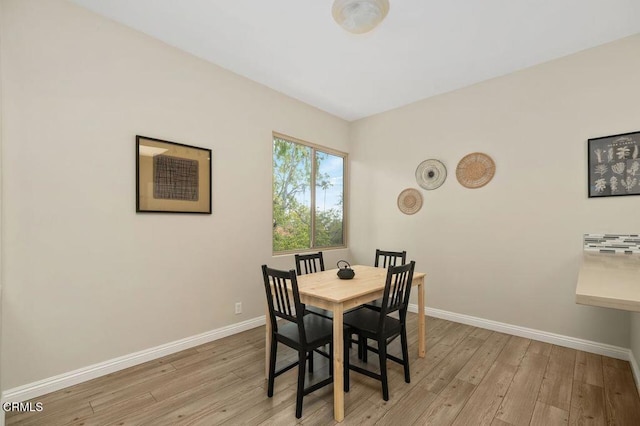 dining room with baseboards and light wood-style floors