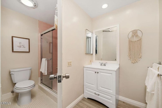 bathroom with baseboards, toilet, recessed lighting, a stall shower, and vanity