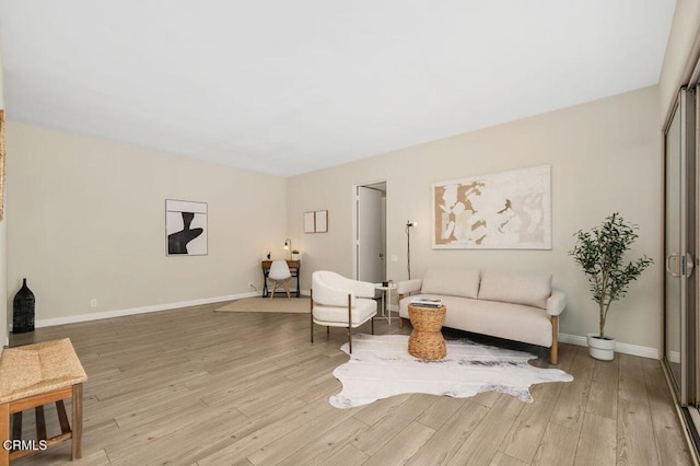 sitting room with light wood-style flooring and baseboards