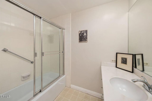 full bath featuring baseboards, enclosed tub / shower combo, and vanity