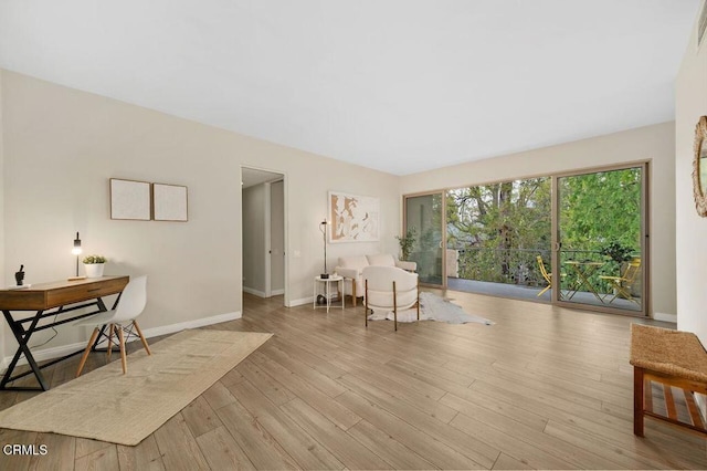 living area featuring visible vents, baseboards, and wood finished floors