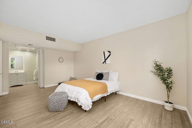 bedroom featuring light wood-type flooring, baseboards, and visible vents