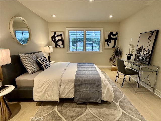 bedroom with recessed lighting, baseboards, and wood finished floors