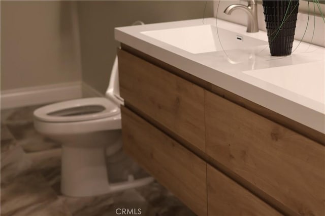 bathroom with toilet and vanity