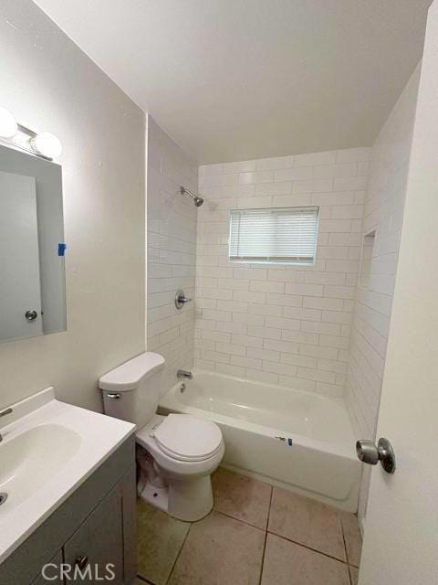 full bath featuring vanity, tile patterned floors, toilet, and washtub / shower combination