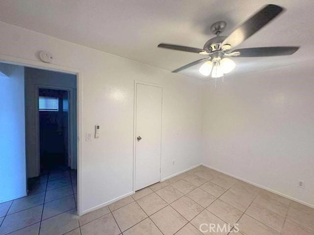 unfurnished bedroom featuring light tile patterned floors and ceiling fan