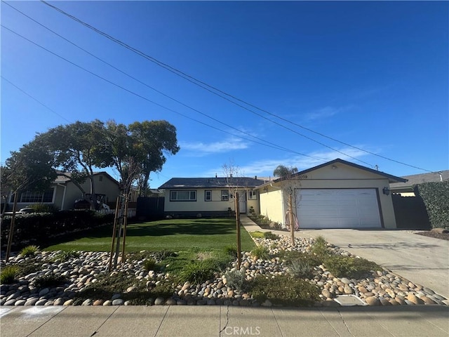 ranch-style house featuring stucco siding, an attached garage, driveway, and a front lawn