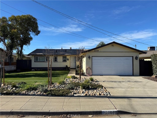 ranch-style house featuring a front yard, fence, driveway, central AC, and a garage