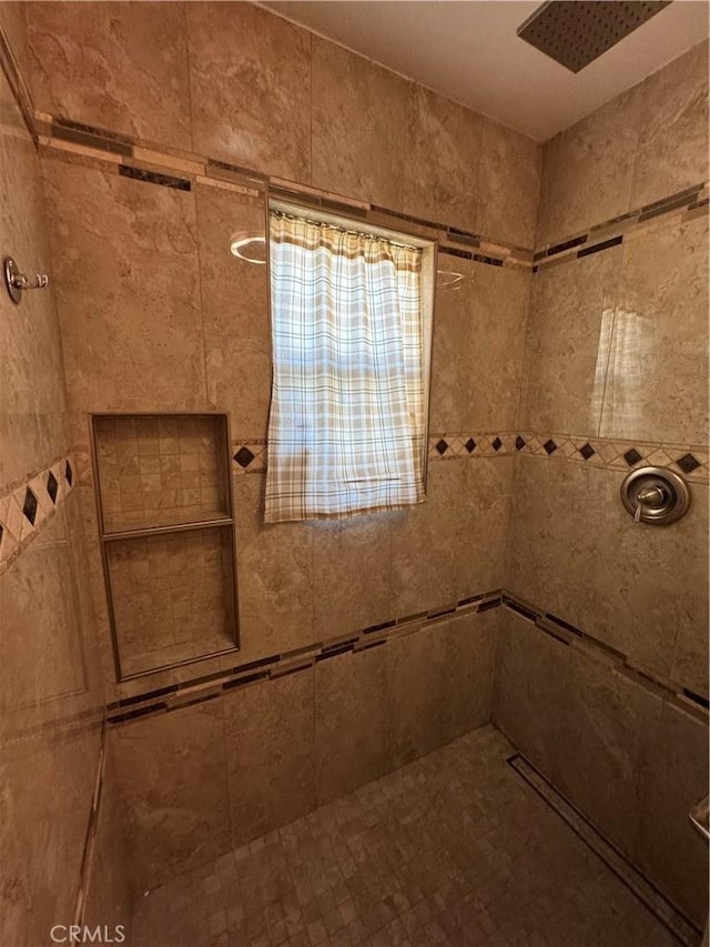 bathroom with tiled shower