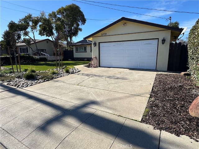 single story home with fence, a front yard, stucco siding, a garage, and driveway