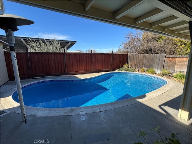 view of swimming pool with a patio area, a fenced backyard, and a fenced in pool