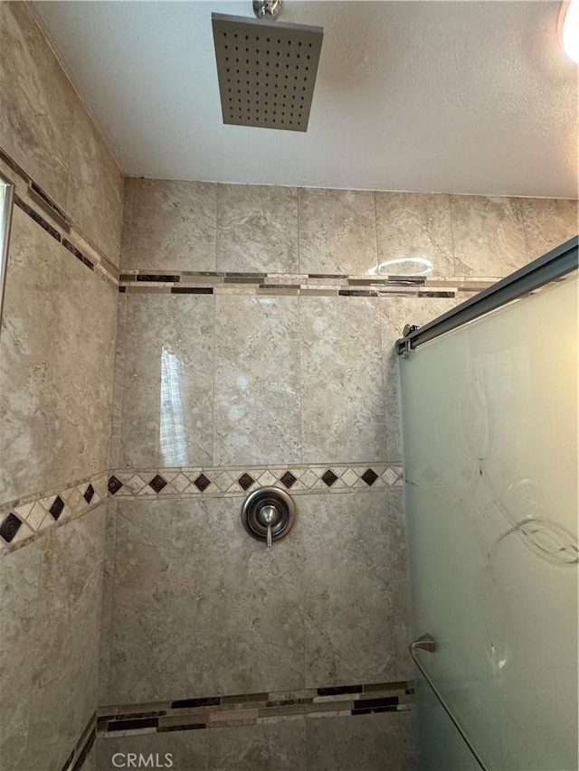 bathroom with a tile shower