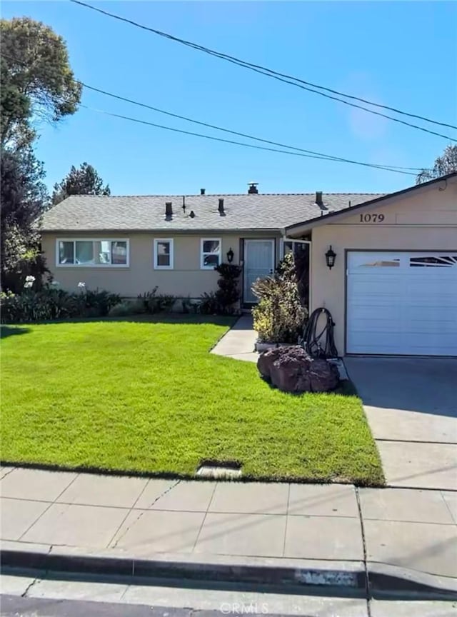 single story home featuring a front yard, roof with shingles, an attached garage, stucco siding, and concrete driveway