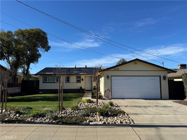 ranch-style house featuring fence, a front yard, stucco siding, driveway, and an attached garage