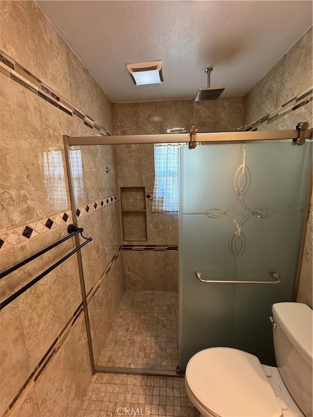 full bath with toilet and a stall shower