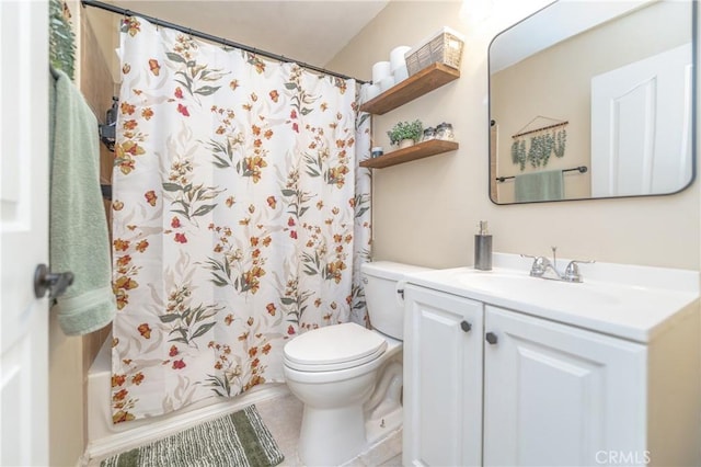 bathroom with tile patterned flooring, toilet, and vanity