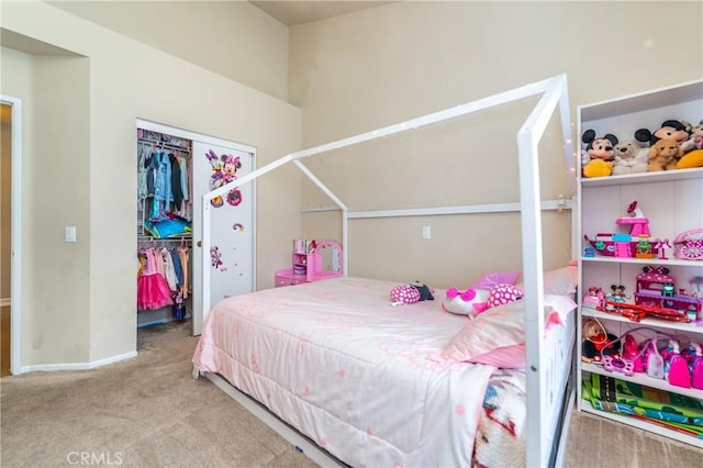 bedroom with a closet, baseboards, and carpet