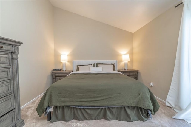 bedroom featuring light colored carpet, baseboards, and vaulted ceiling