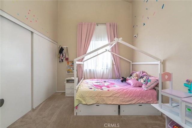 carpeted bedroom with a closet