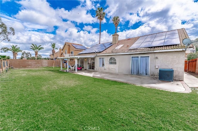 back of property with stucco siding, a lawn, a patio, a fenced backyard, and a tiled roof