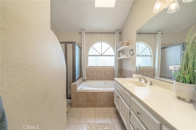 full bathroom with tile patterned floors, a shower stall, vanity, and a garden tub