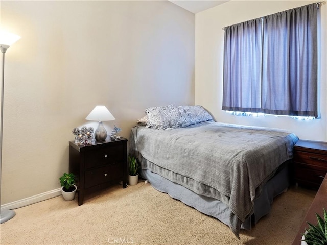 bedroom featuring baseboards and carpet floors