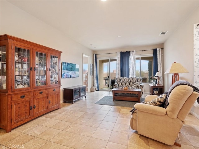 living area featuring light tile patterned floors and visible vents