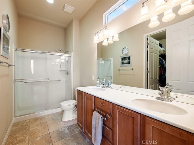 bathroom with double vanity, visible vents, a stall shower, and a sink