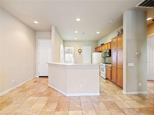 kitchen featuring stainless steel microwave, visible vents, gas range gas stove, recessed lighting, and brown cabinets